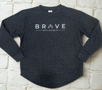 Black leopard print relaxed fit crewneck sweatshirt with 'BRAVE' text on a light brick background. Motivational. Give Back brand.